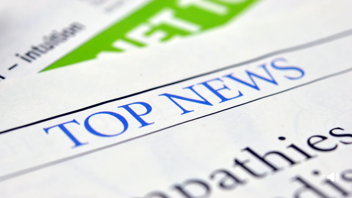 Close-up of a newspaper page headed TOP NEWS.