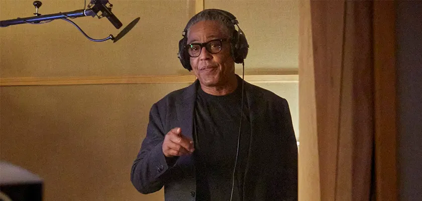 Actor Giancarlo Esposito wearing headphones in a recording studio.