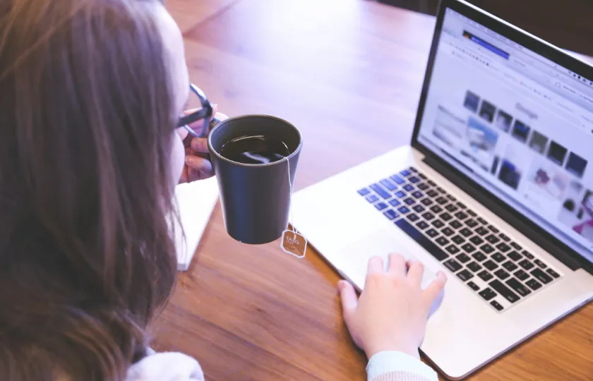 Woman using laptop discovering closing digital divides: ReadSpeaker TTS and the 2024 National Edtech Plan